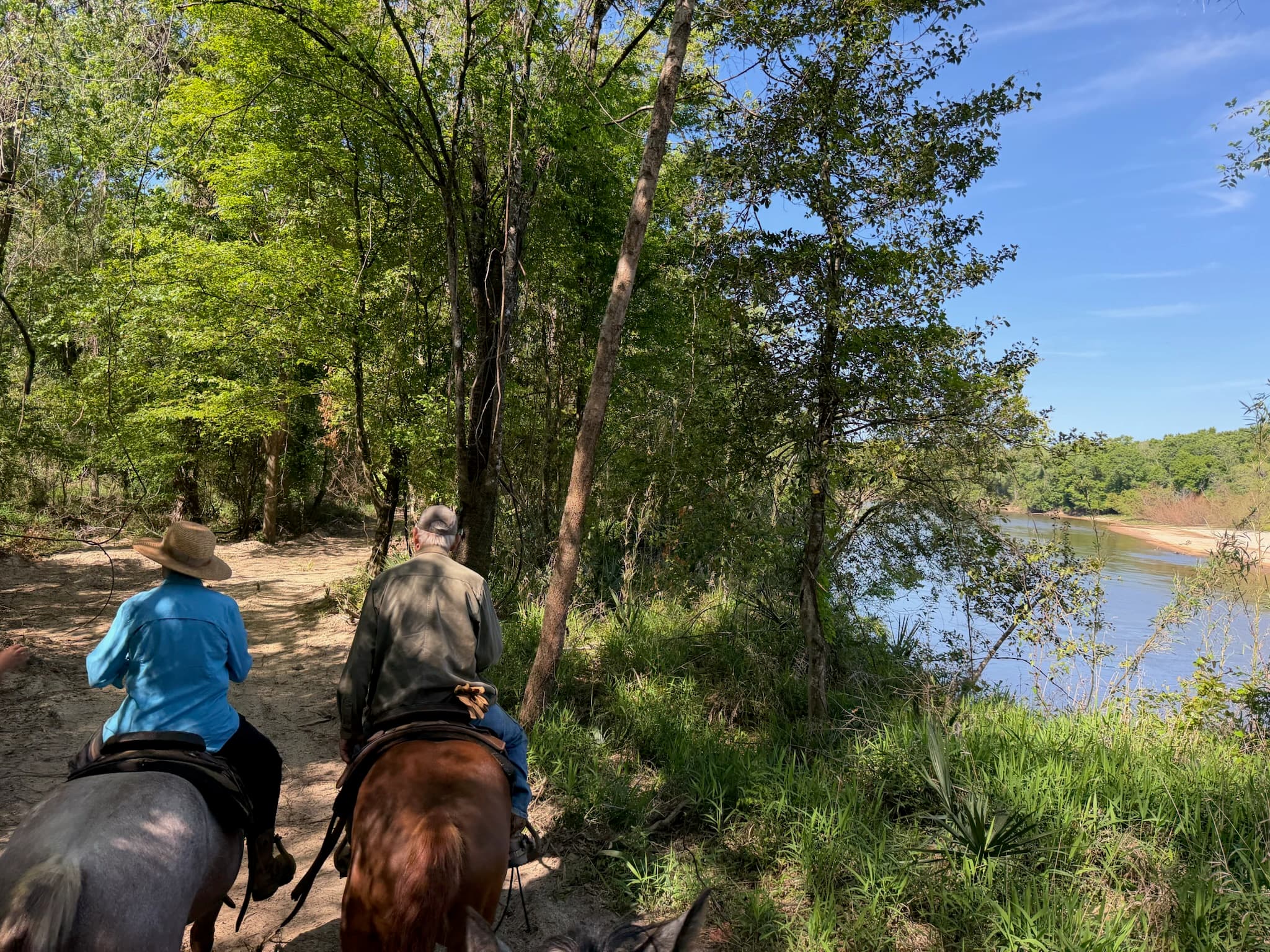 Riding horseback along the river at River Woods Ranch