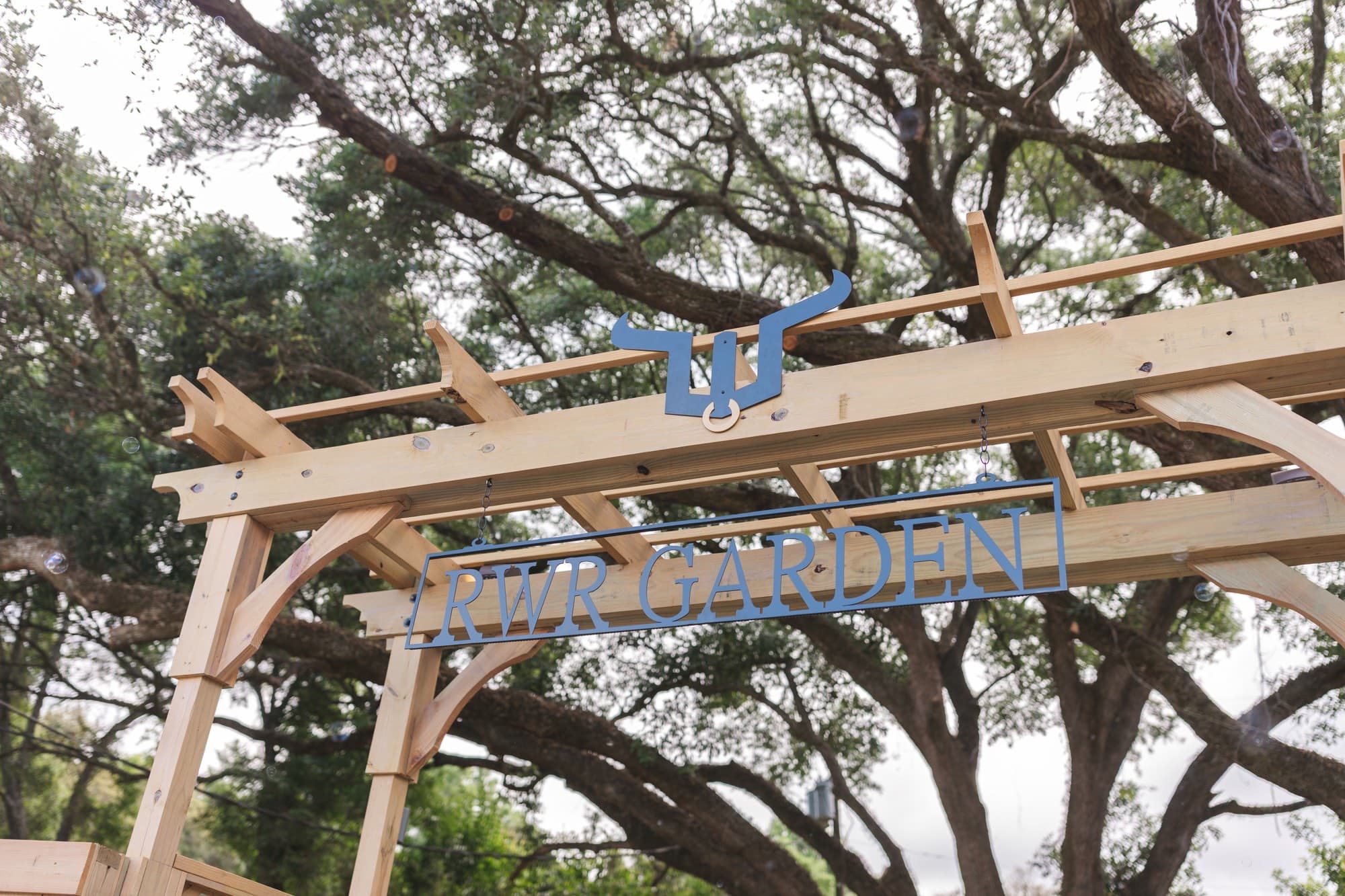 A pergola set beneath the oaks at River Woods Ranch
