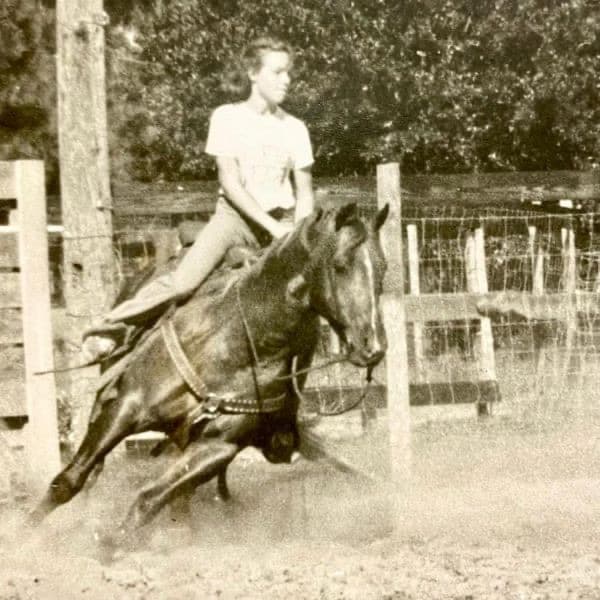 A young rider working a horse in the arena